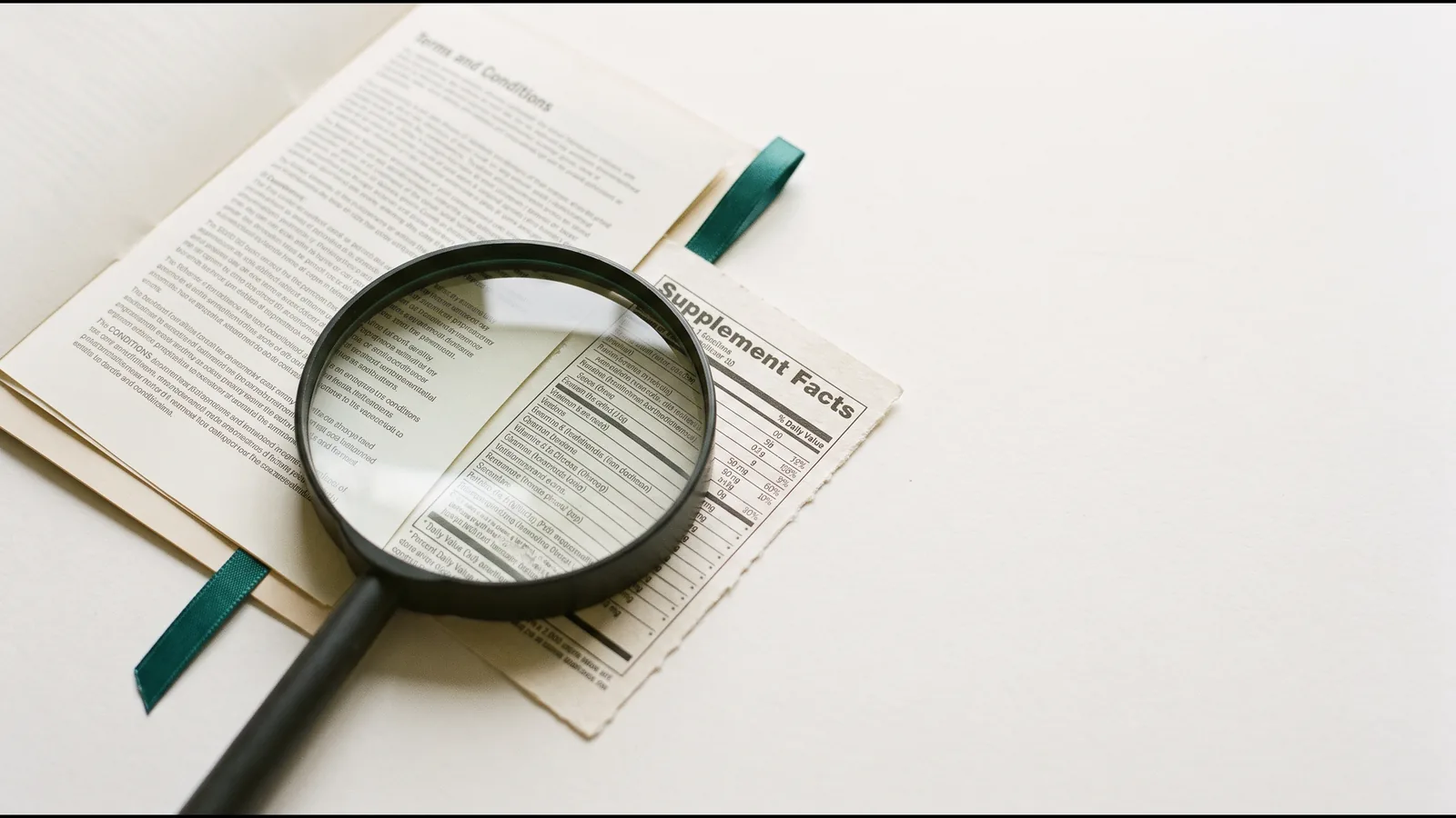 A magnifying glass resting on the fine print of a product label